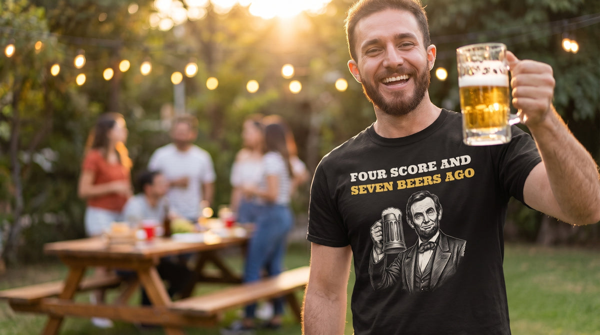 Laughing man raising a beer at a backyard cookout in the Four Score And Seven Beers Ago tee